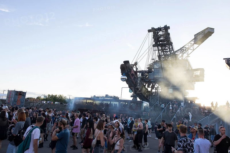 The sun sets for the last time behind one of the open-cast mining excavators at the Melt Festival in Ferropolis on 13 July 2024. After a total of 27 years, the festival will take place for the last time in 2024