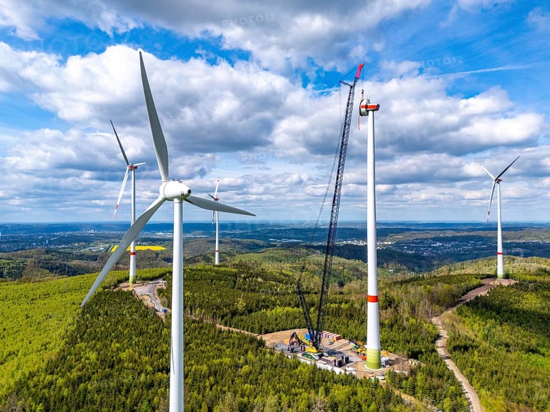 Erection of a wind turbine, wind energy plant, assembly of the ring generator, with a crawler lattice crane, wind farm near Hagen, North Rhine-Westphalia, Germany, Europe