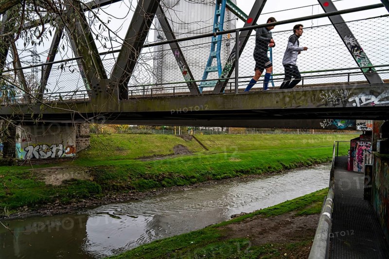 The River Emscher, sewage river, old railway bridge, now a footpath and cycle path, bridge for local buses and trams, in Oberhausen, North Rhine-Westphalia, Germany, Europe