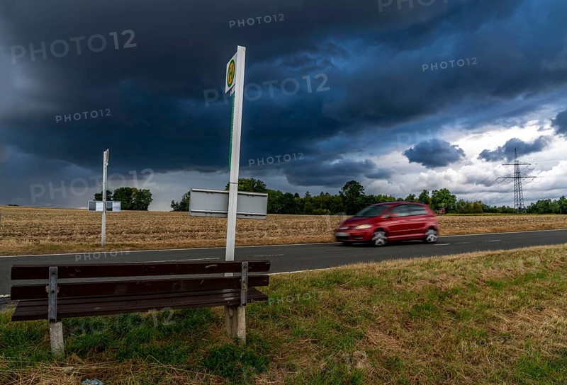 Single stop of bus line 510 between Korbach and Bad Wildungen, country road near Waldeck in North Hesse, bus stop Abzweig Netze, bus traffic between 6 a.m. and 5 p.m., NVV, Nordhessische VerkehrsVerbund, thunderstorm front approaching, Germany, Europe