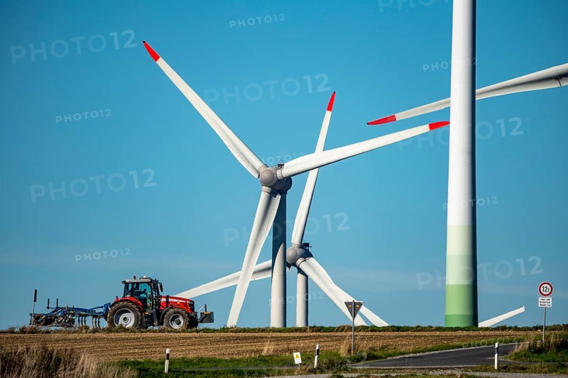 Wind farm near Lichtenau, wind turbines, country road, Driburger Straße, tractor at work in the field, North Rhine-Westphalia, Germany, Europe