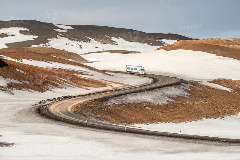 Truck on mountain road between Reykjahlid and geothermal area Hverarönd, winter, at mountain Námafjall, Myvatn area, North Iceland