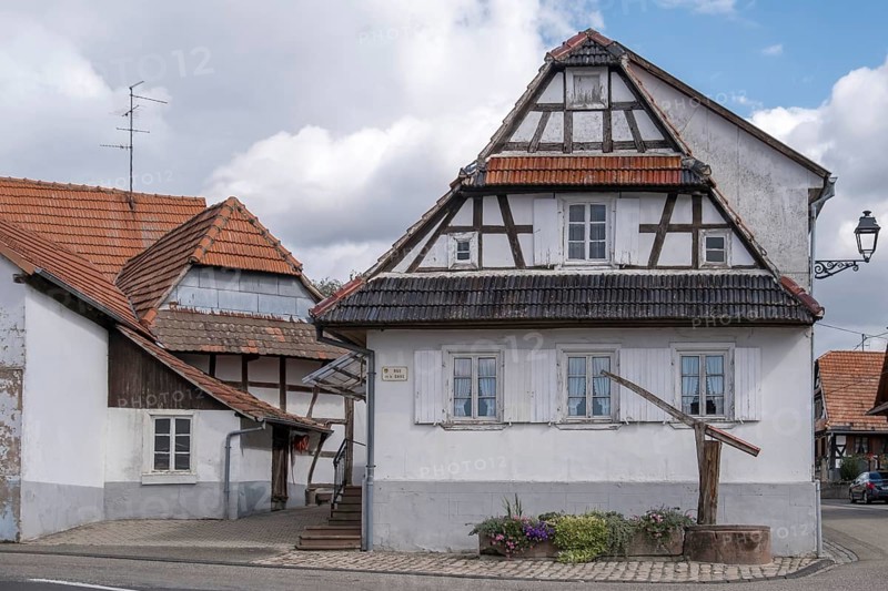 Old fountain in front of a half-timbered house, Hunspach, Alsace