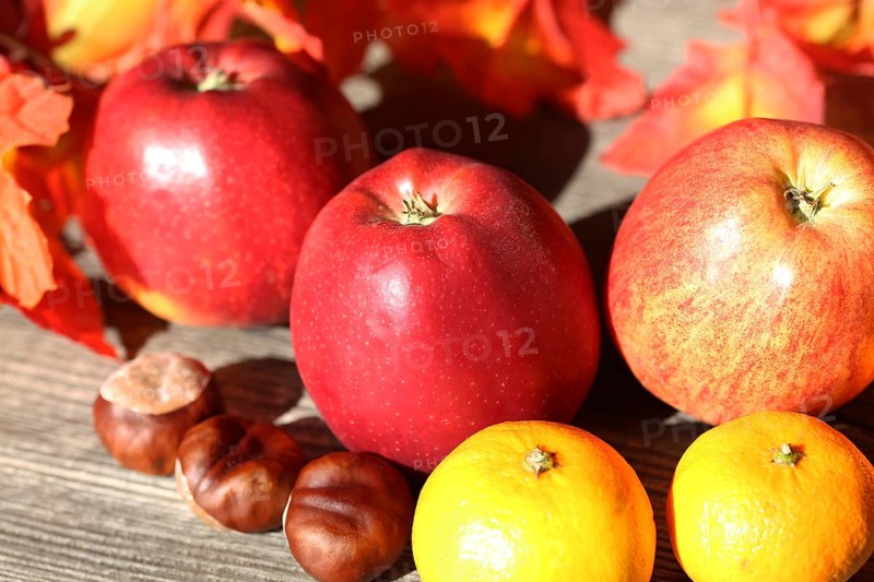 Apples and mandarins on a rustic wooden table as an autumnal motif