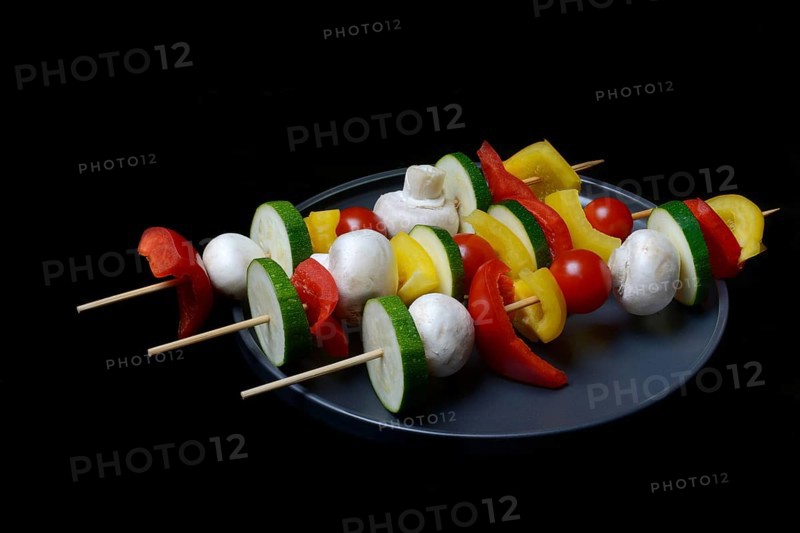 Colourful vegetable skewers on a plate, barbecue skewers