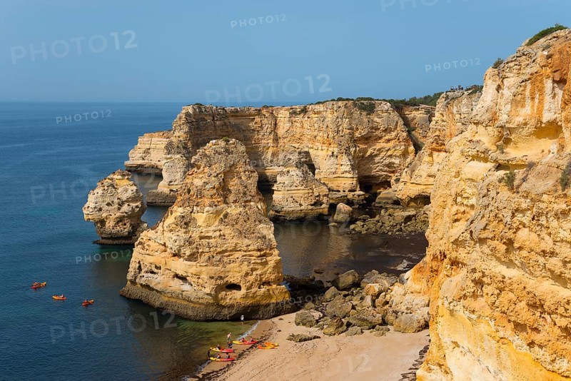 Majestic cliffs meet the calm sea on a sunny day with a golden sandy beach and blue sky, Praia da Marinha, Lagoa, Rocky Algarve, Algarve, Portugal, Europe