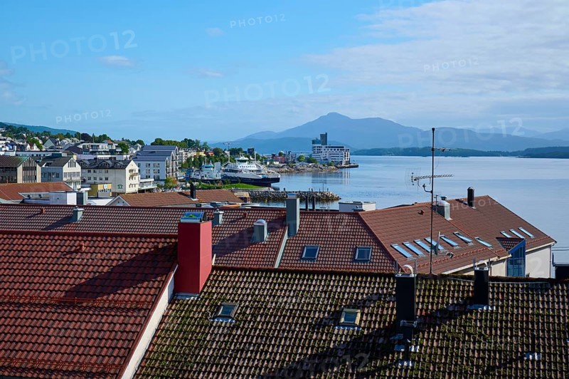 City view with red roofs of Molde, fjord landscape, sea, mountains in the background and blue, cloudy sky, Molde, Romsdal, Norway, Europe
