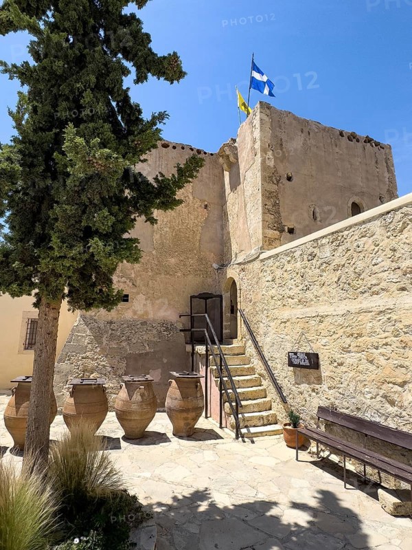 View of the historic monastery defence tower Xopatera tower 19th century tower of Xopatera Xopateras in front of large clay pots in the courtyard of the Unesco Site Orthodox Greek Orthodox Monastery of Moni Odigitria, Festos, Crete, Greece, Europe
