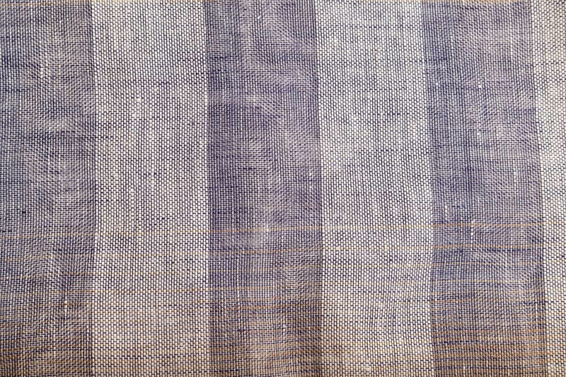 Fragment of smooth brown and violet linen tissue. Top view, flat lay, natural textile background and texture