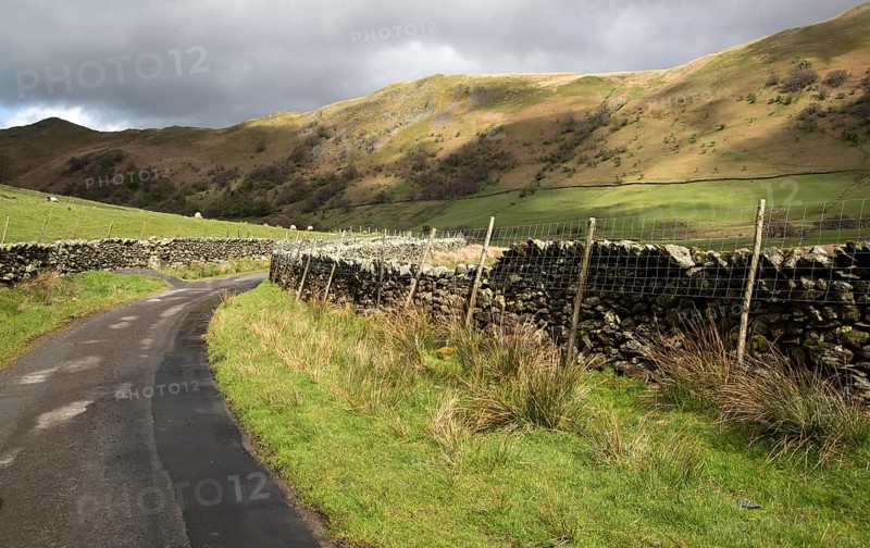 Narrow country road in Martindale valley, Ullswater, Lake District national park, Cumbria, England, UK