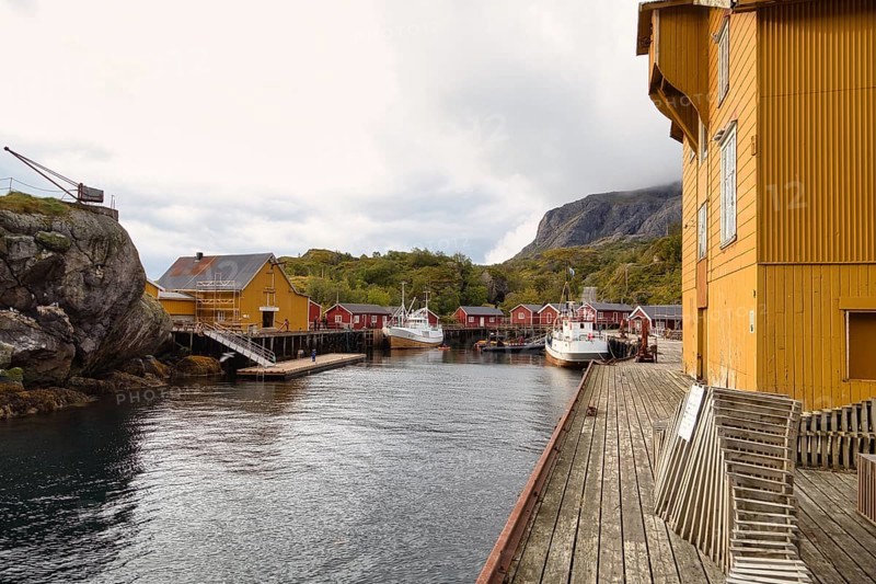 Historic buildings and fishing boats in the harbour of Nusfjord, Lofoten, Nordland, Norway, Europe