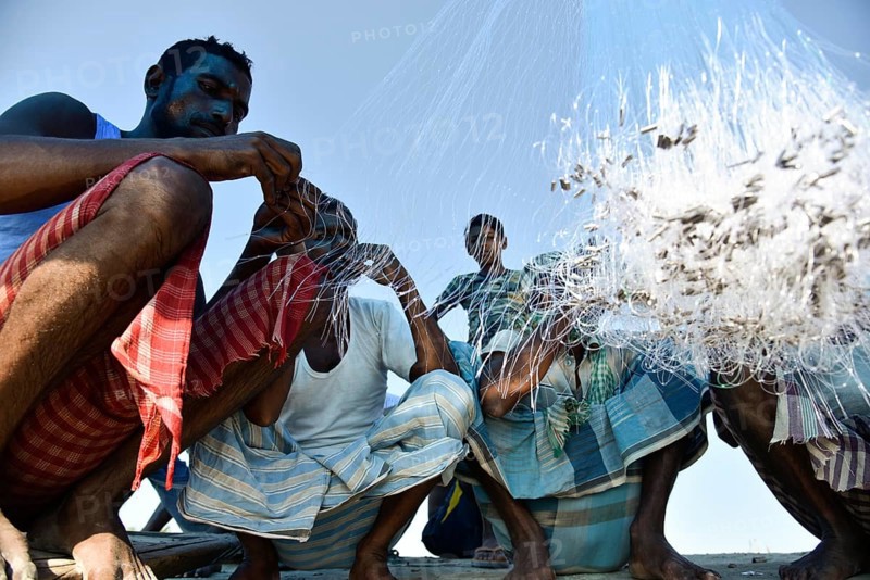 Fishermen knitting fishing net in the banks of Beki river, in Barpeta district of Assam, India on 01 Nov. 2019