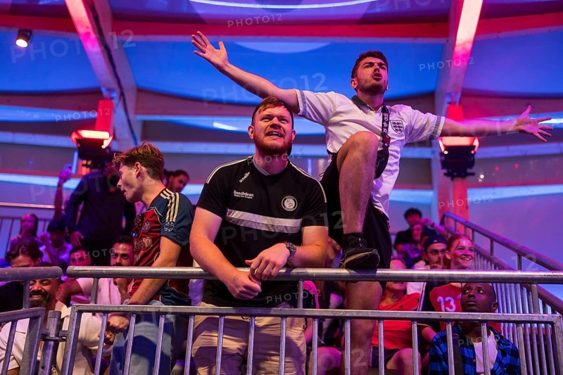 Fans of the British team gesticulate loudly at the Adidas fan zone at the Bundestag during the final match between Spain and England at the European Football Championship, Berlin, 14 July 2024
