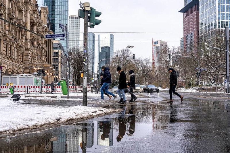 Winter in the city, Gallusanlage street, puddles, pools of water, melt water, pedestrians, Frankfurt, Hesse, Germany, Europe