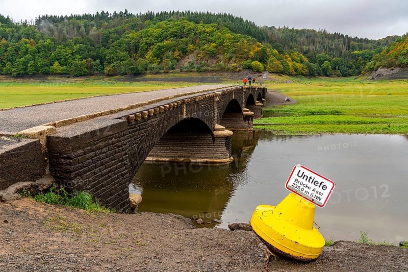 The Edersee, near Waldeck, the third largest reservoir in Germany, currently has only just under 13% of its normal level, the lake was last full in May 2022, dried out due to lack of rain, Asel bridge, exposed by the low water, otherwise flooded, the lake shore and the lake bottom is overgrown with fresh grass, Hesse, Germany, Europe