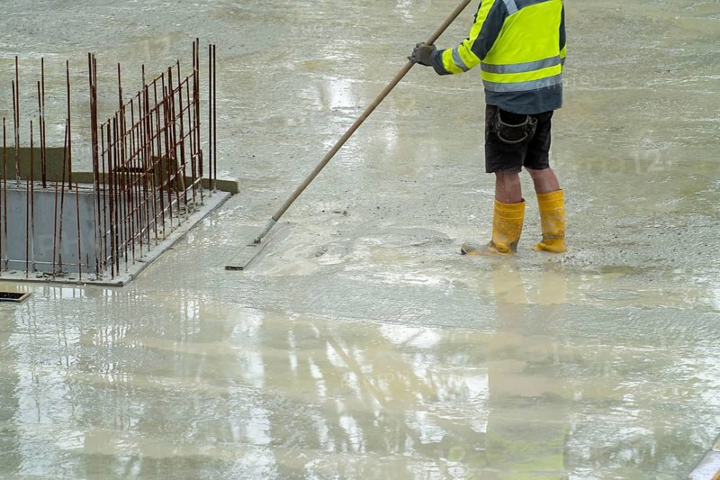 Construction site, concreting, the floor slab of a building is concreted, the fresh concrete is levelled
