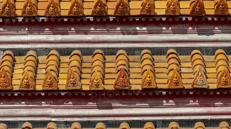 Roof decoration at the Uposatha Hall, Ubosot, the roof is staggered in three tiers and covered with rows of golden yellow glazed Chinese tiles, the last tile of each row at the eaves represents a heavenly angel offering the traditional Thai obeisance Wai to the viewer with folded hands, Wat Benchamabophit, marble temple, Bangkok, Thailand, Asia