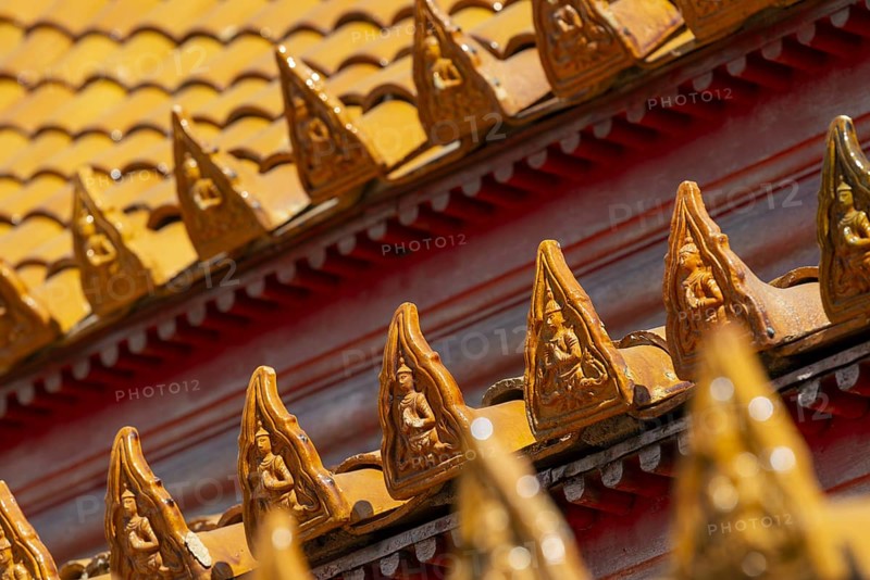 Roof decoration at the Uposatha Hall, Ubosot, the roof is staggered in three tiers and covered with rows of golden yellow glazed Chinese tiles, the last tile of each row at the eaves represents a heavenly angel offering the traditional Thai obeisance Wai to the viewer with folded hands, Wat Benchamabophit, marble temple, Bangkok, Thailand, Asia