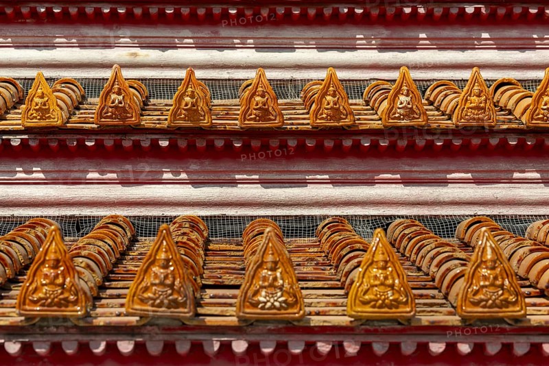 Roof decoration at the Uposatha Hall, Ubosot, the roof is staggered in three tiers and covered with rows of golden yellow glazed Chinese tiles, the last tile of each row at the eaves represents a heavenly angel offering the traditional Thai obeisance Wai to the viewer with folded hands, Wat Benchamabophit, marble temple, Bangkok, Thailand, Asia