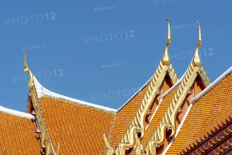 Roof decoration at the Uposatha Hall, Ubosot, the roof is staggered in three tiers and covered with rows of golden yellow glazed Chinese tiles, the last tile of each row at the eaves represents a heavenly angel offering the traditional Thai obeisance Wai to the viewer with folded hands, Wat Benchamabophit, marble temple, Bangkok, Thailand, Asia
