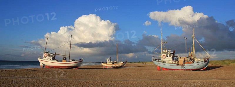 Summer clouds over fishing boats at the Slettestrand, Denmark, Europe