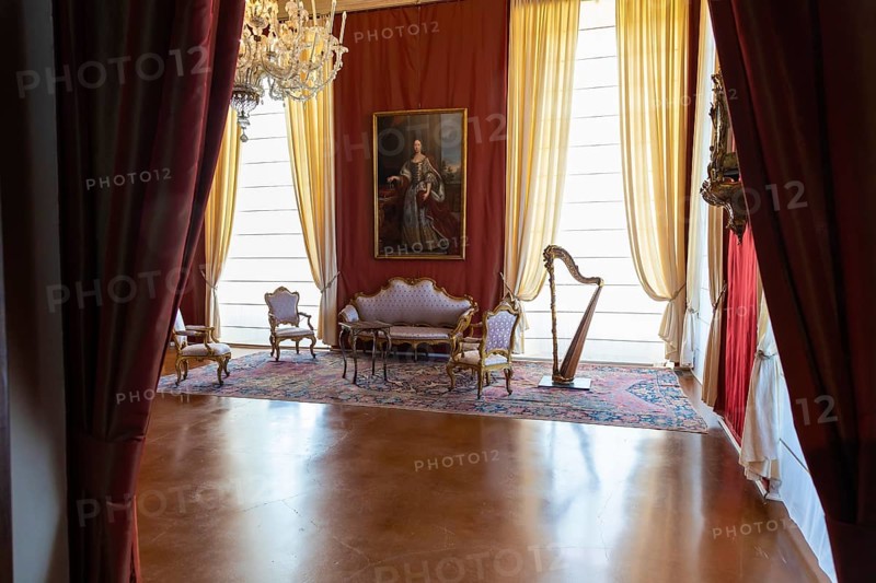 Venaria Reale, Italy, February 2023: luxury interior, old Royal Palace. Perspective with harp, window and baroque decoration, Europe
