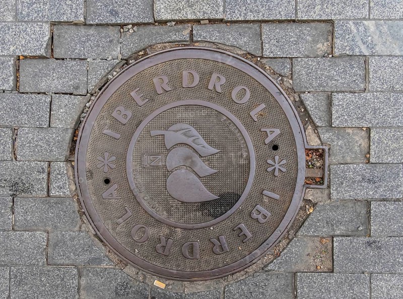 Madrid manhole cover on a busy street in Madrid, Spain, Europe