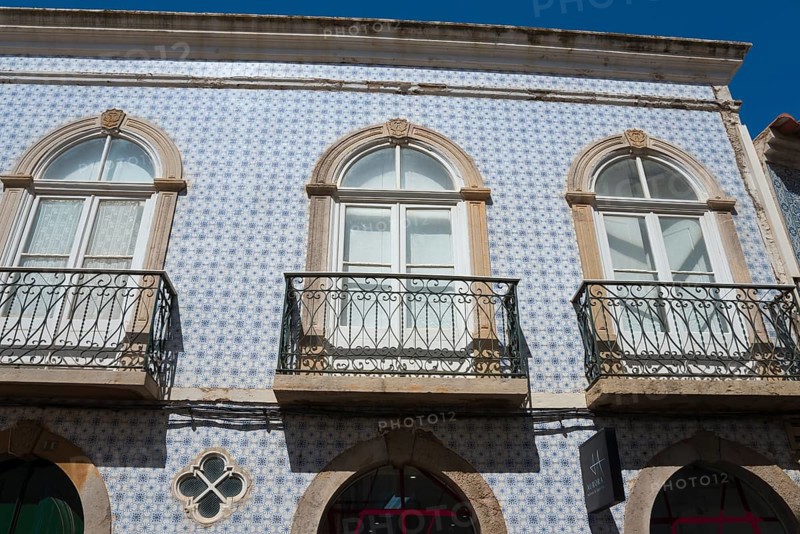 Facade of a house with blue azulejos and wrought-iron balconies in traditional Portuguese style, Praça Dr António Padinha, Tavira, Faro, Algarve, Portugal, Europe