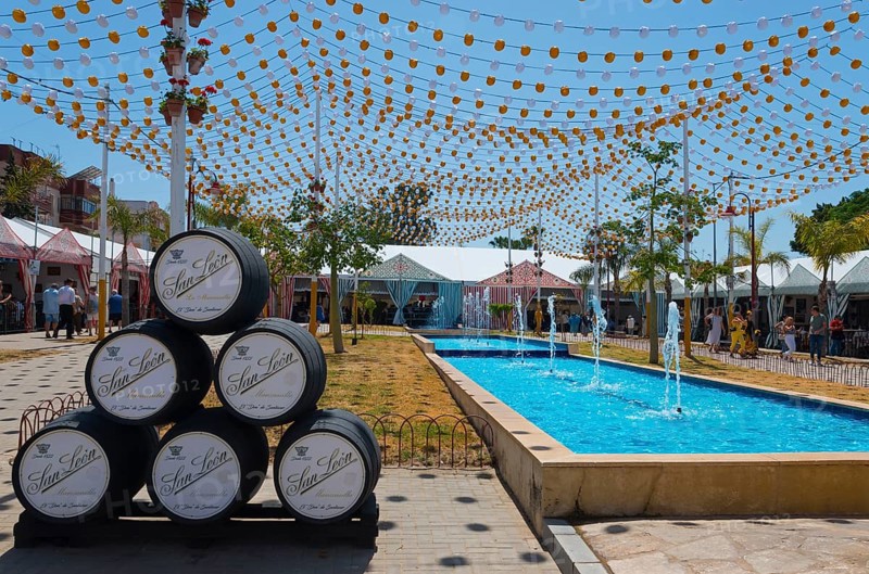 Colourful fairy lights over barrels next to a water basin, festive atmosphere, Feria de la Manzanilla, Feria de Sanlúcar, Sanlúcar de Barrameda, Sanlucar, Province of Cádiz, Cadiz, Andalusia, Spain, Europe