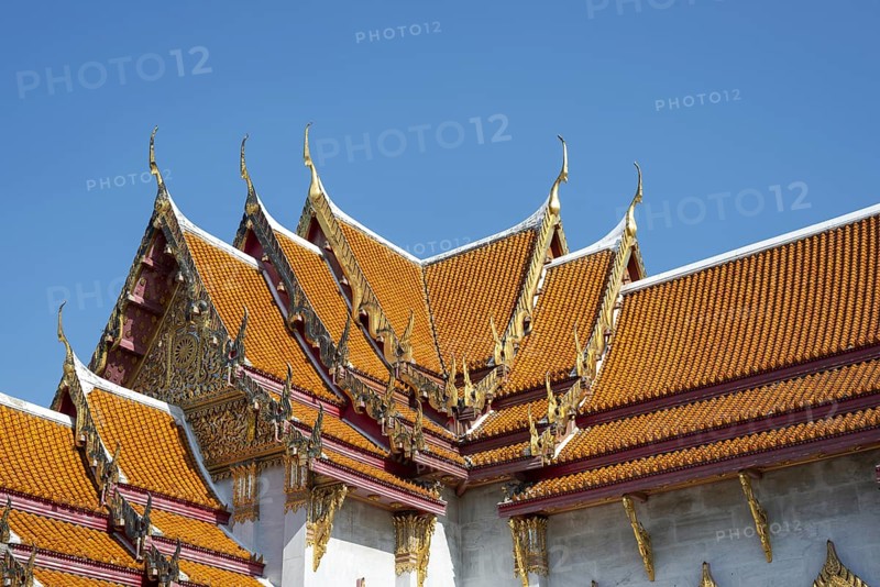Roof decoration at the Uposatha Hall, Ubosot, the roof is staggered in three tiers and covered with rows of golden yellow glazed Chinese tiles, the last tile of each row at the eaves represents a heavenly angel offering the traditional Thai obeisance Wai to the viewer with folded hands, Wat Benchamabophit, marble temple, Bangkok, Thailand, Asia