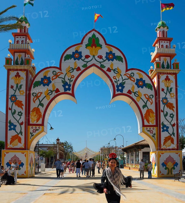 Colourful gate with floral patterns, people in the background, festive atmosphere, Feria de la Manzanilla, Feria de Sanlúcar, Sanlúcar de Barrameda, Sanlucar, Cádiz, Cadiz, Andalusia, Spain, Europe