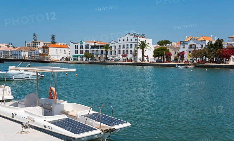 Riverside town with boats on a promenade under a clear sky in the Algarve, Gilão River, Gilao, Tavira, Faro, Algarve, Portugal, Europe