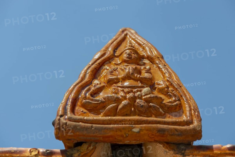 Roof decoration at the Uposatha Hall, Ubosot, the roof is staggered in three tiers and covered with rows of golden yellow glazed Chinese tiles, the last tile of each row at the eaves represents a heavenly angel offering the traditional Thai obeisance Wai to the viewer with folded hands, Wat Benchamabophit, marble temple, Bangkok, Thailand, Asia