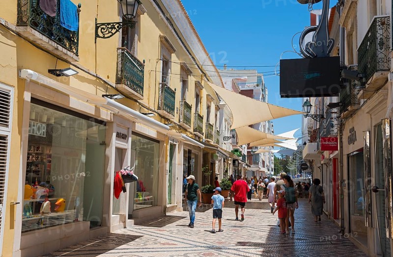 Lively shopping street with shops, people and awnings in Mediterranean style, pedestrian zone, old town, Faro, Algarve, Portugal, Europe