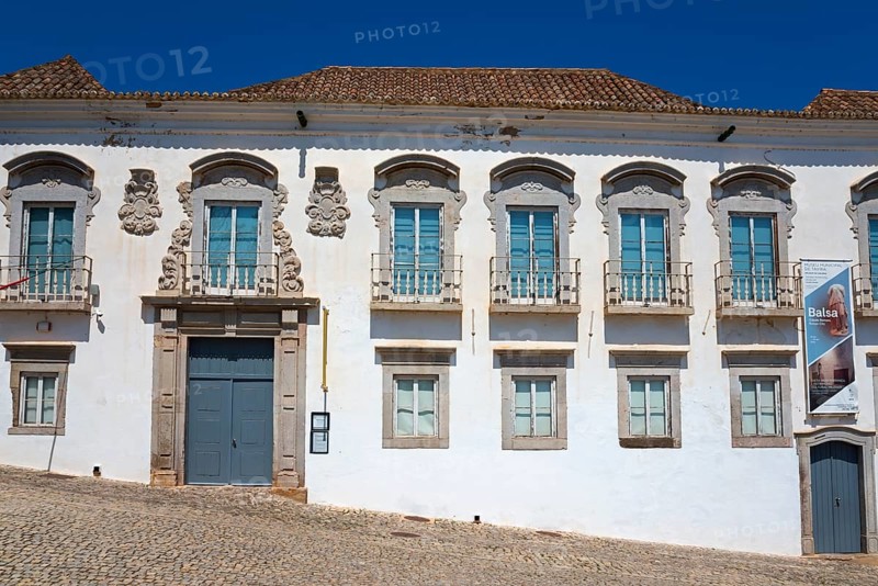 Historic building with symmetrical façade and decorative window elements under a blue sky, Museu Municipal, Palácio da Galeria, Tavira, Faro, Algarve, Portugal, Europe