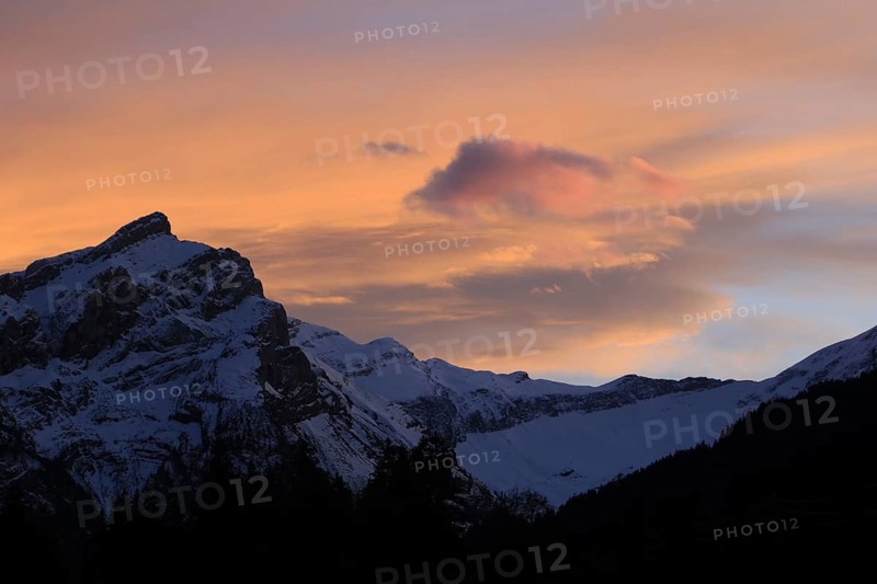Bright orange clouds over Mount Oldehore, Switzerland, Europe
