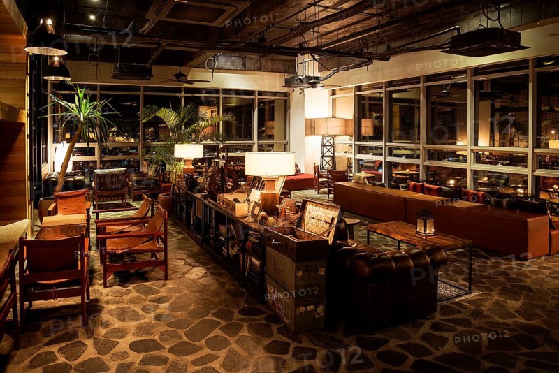 Cozy lounge area of trendy design bar at night