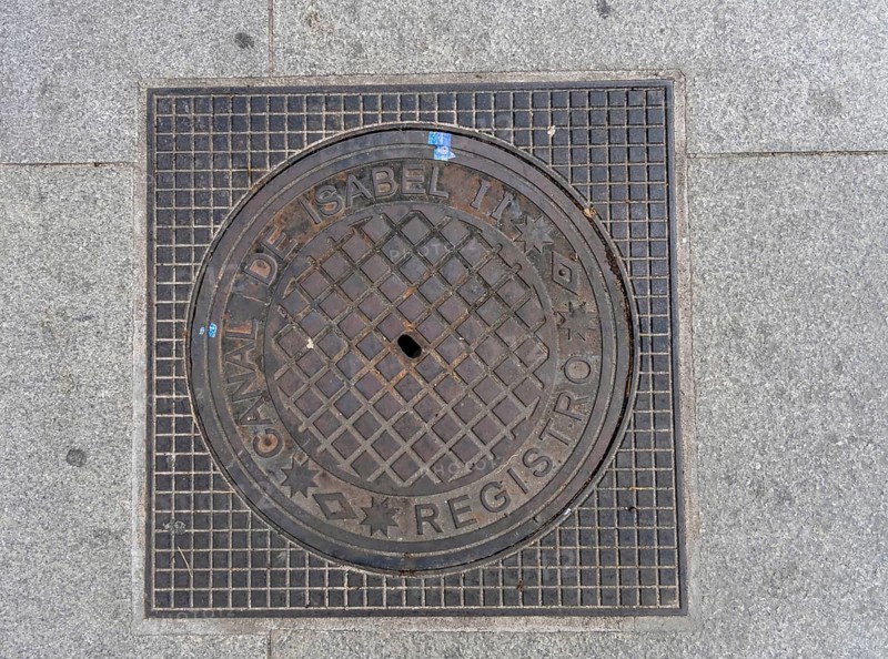Madrid manhole cover on a busy street in Madrid, Spain, Europe