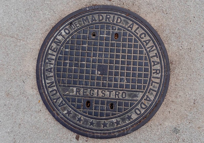 Madrid manhole cover on a busy street in Madrid, Spain, Europe