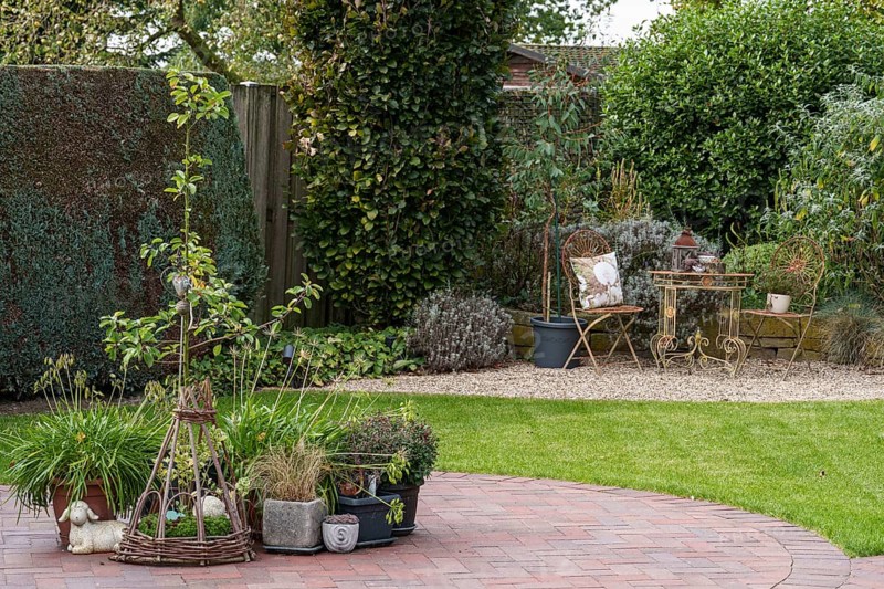 Garden with plant arrangement and seating area on a gravel path, Weseke, Münsterland, Germany, Europe