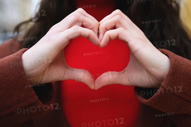 A close-up of a woman making a gesture of love. Valentines day