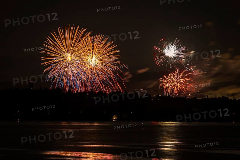 Fireworks over a lake with a reflection in the water