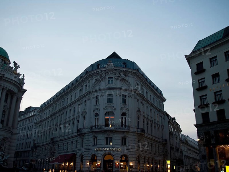 Evening street scene with illuminated facades and charming café on the corner, Vienna, Austria, Europe