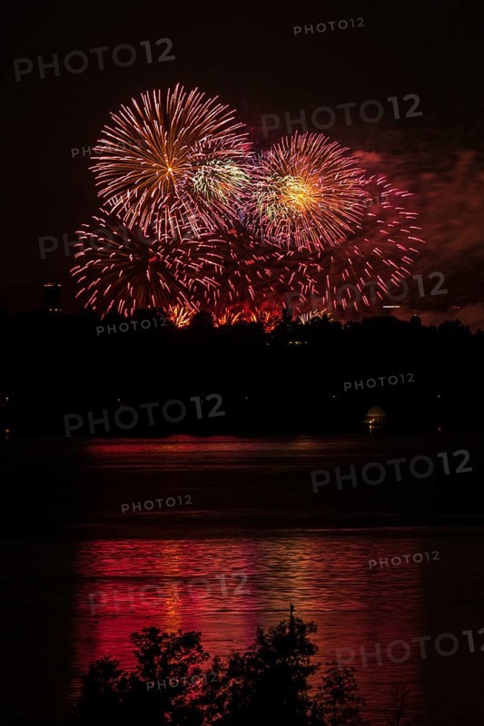 Fireworks over a lake with a reflection in the water