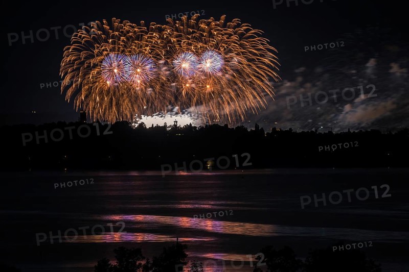 Fireworks over a lake with a reflection in the water