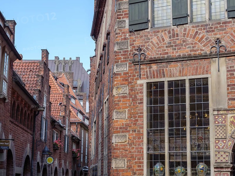 Narrow alley in an old town with historic brick buildings and a window with muntin bars, Bremen, Germany, Europe