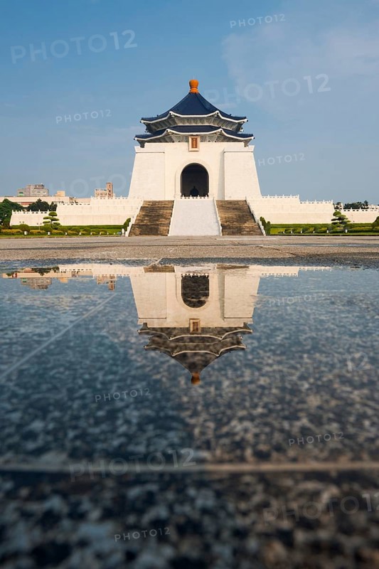 The Chiang Kai Shek Memorial Hall reflected in a puddle of rainwater