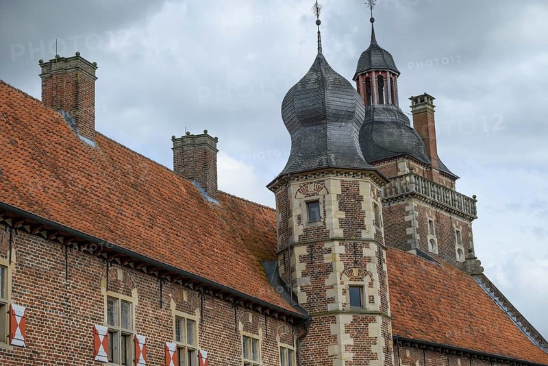Historic castle with striking towers and red tiled roofs against a cloudy sky, Raesfeld, North Rhine-Westphalia, Germany, Europe