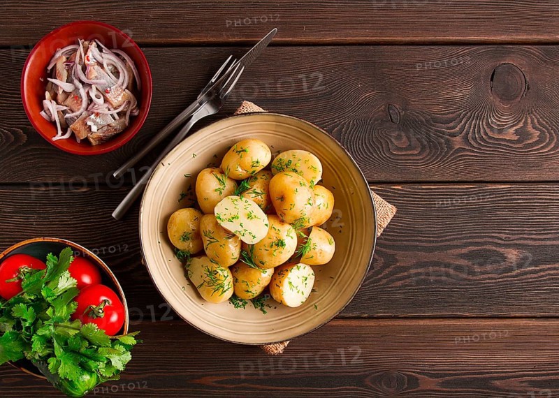 Fresh Cooked, new potatoes, with dill, on a wooden table, selective focus. close-up, toning, no people