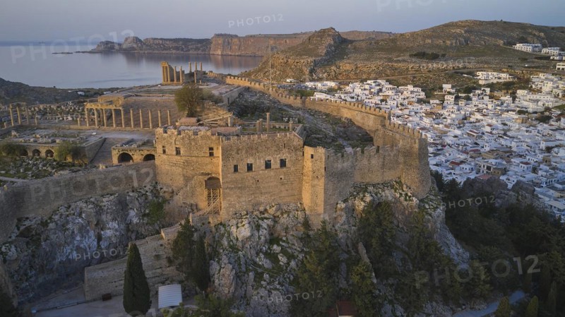 Drone shot, first morning light, Lindos, Acropolis of Lindos, Propylaea with open staircase, Ancient ruins above a city with white buildings and mountains in the background, Archaeological site, Lindos, Rhodes, Dodecanese, Greek Islands, Greece, Europe